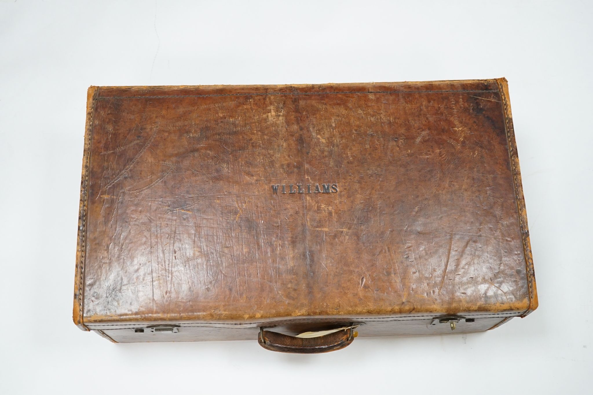 A leather suitcase., 77cms wide x 27 cms high.
